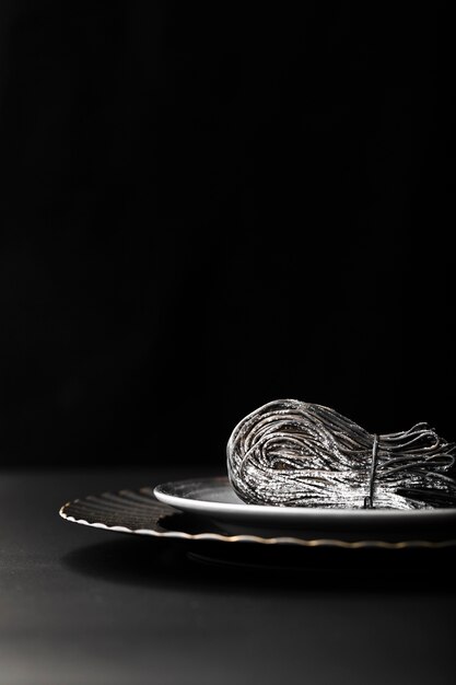 Dark pasta plate on a dark background