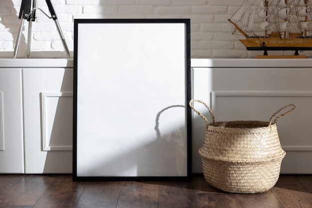 Dark photo frame and basket on floor