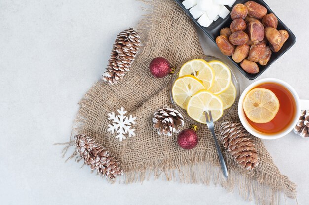 A dark plate of loafsugar and dried fruit on white background. High quality photo