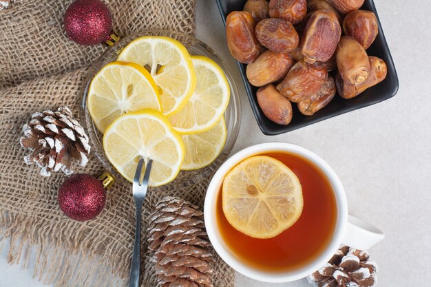 A dark plate of loafsugar and dried fruit on white background. High quality photo