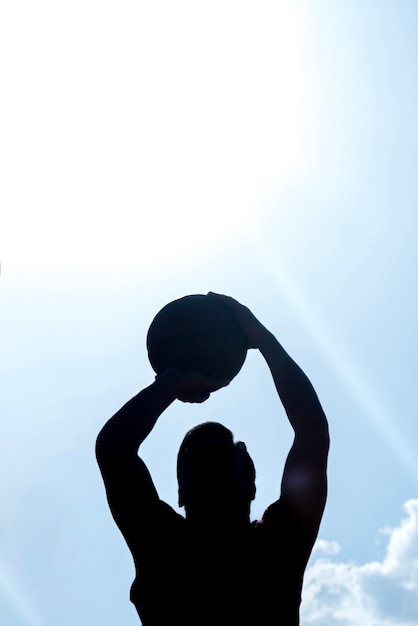 Dark silhouette of basketball player