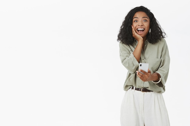 Dark skinned woman  feeling happy and surprised