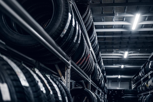 Dark storage full or big variety of new tyres at busy warehouse.