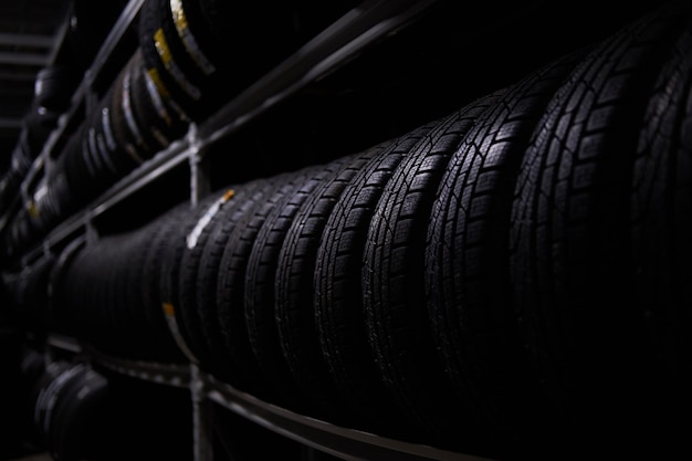 Free photo dark storage full or big variety of new tyres at busy warehouse.