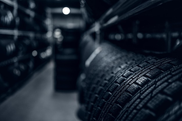 Dark storage full or big variety of new tyres at busy warehouse.