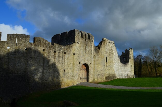 Dark storm clouds over the ruins of Desmond Castle in Ireland.