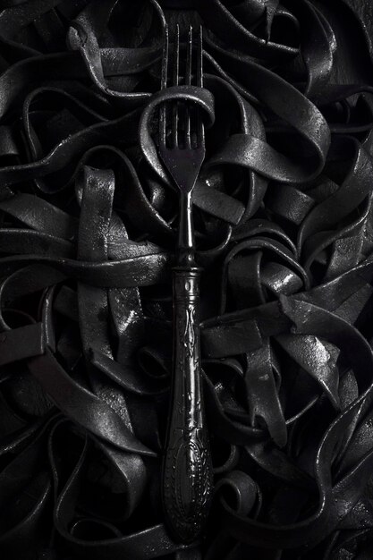 Dark tagliatelle pasta with fork