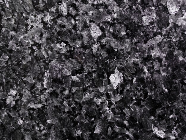 Dark textured background of granite stone