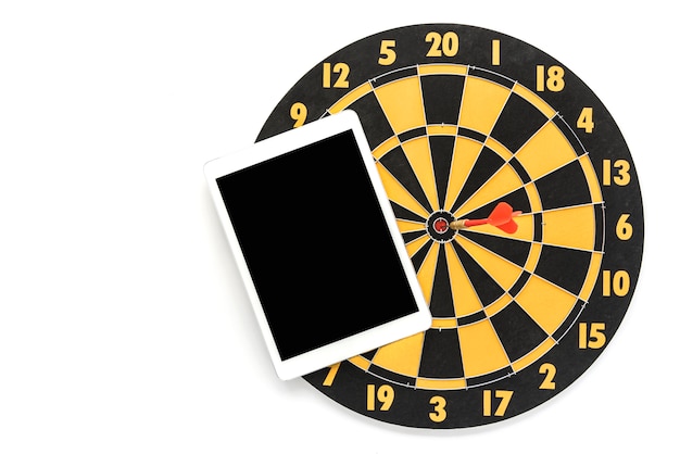 Dart target on bullseye with blank black screen tablet