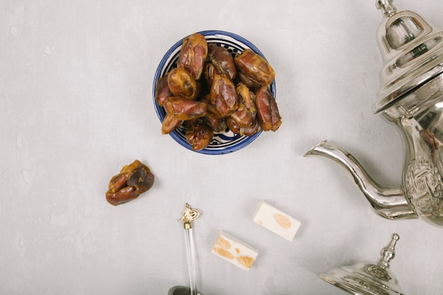 Dates fruit in bowl with Turkish delight and teapot