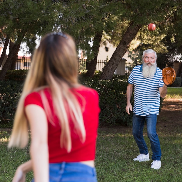 Daugher trowing ball at his father