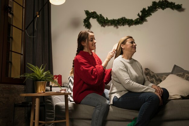 Daughter brushing her mothers hair