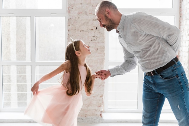 Daughter and dad dancing on fathers day