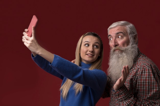 Free photo daughter and dad taking a selfie