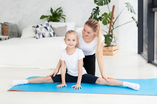 Daughter exercising with mother at home