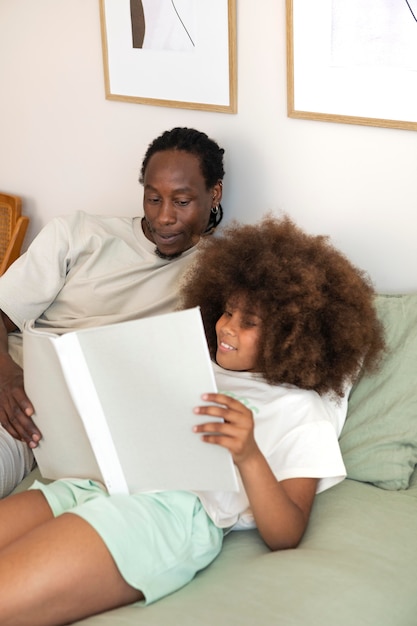 Daughter and father reading a book together