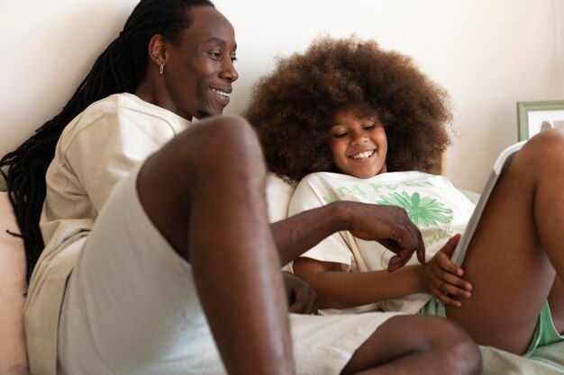 Daughter and father reading a book together