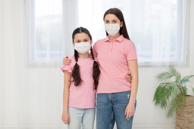 Daughter and girl wearing masks