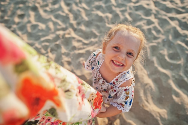 Daughter having fun on the beach Portrait of happy cute little baby girl on vacation