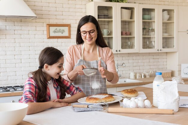 Daughter helping mom to cook