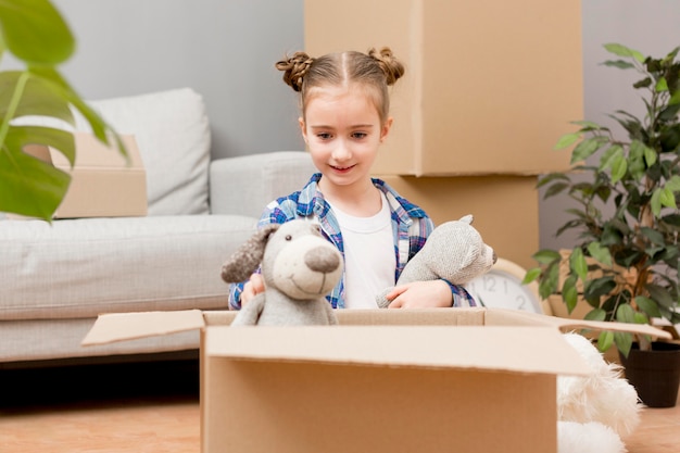 Daughter helping packing the boxes