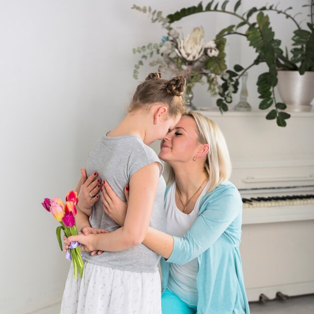 Daughter hiding tulips for mother