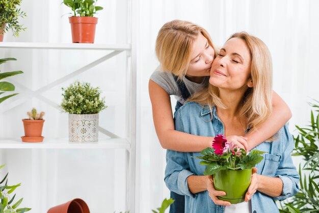 Daughter kissing her mom