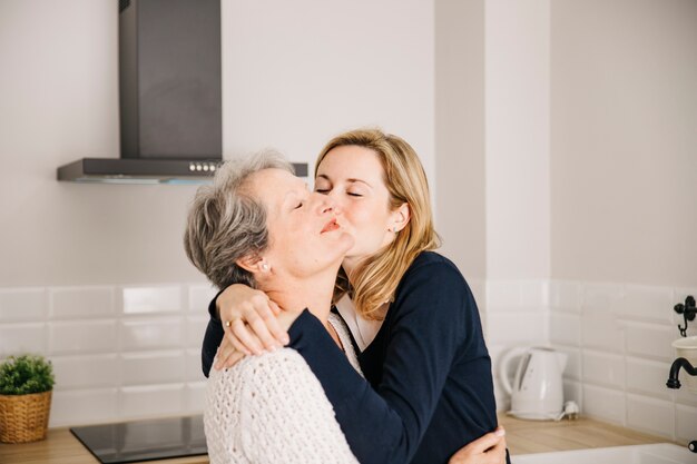 Daughter kissing mom on mothers day