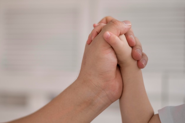 Daughter and mom holding hands