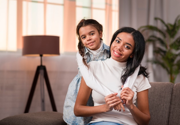 Daughter and mom hugging on couch