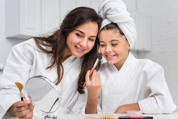 Daughter and mother doing their make-up