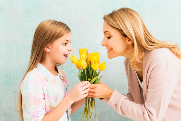 Daughter and mother holding tulips