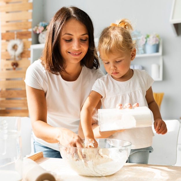 Daughter and mother preparing dough