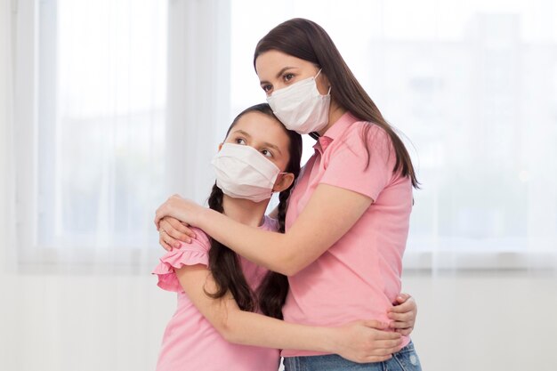 Daughter and mother wearing medical masks