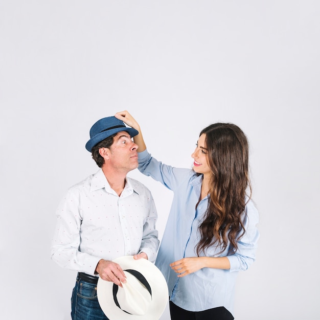 Daughter putting hat on father