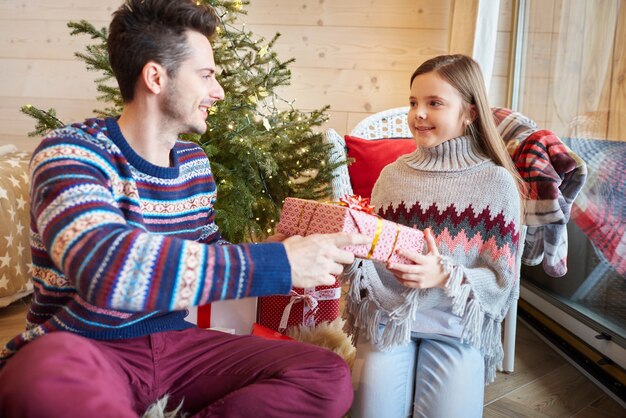 Daughter receiving Christmas present from dad