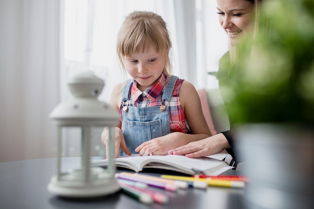 Daughter studying with mother