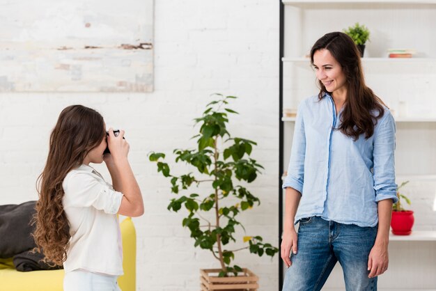 Daughter taking a photo of her mother