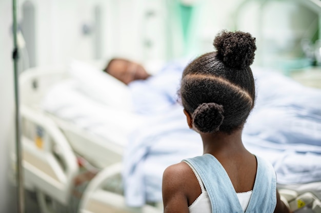 Daughter watching her grandmother sleep at the hospital