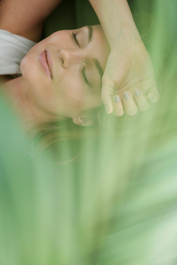 Free Photo daydreaming woman and blurred house plant