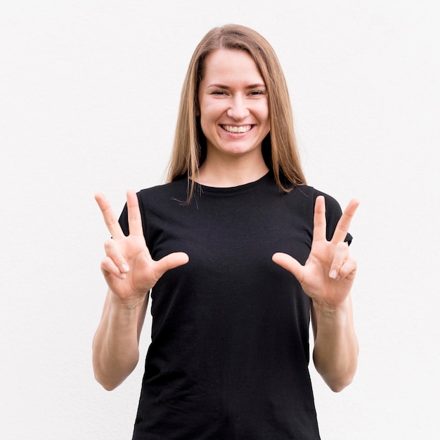 Free photo deaf woman communicating through sign language