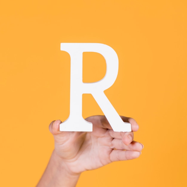 Deaf woman's hand holding r alphabet