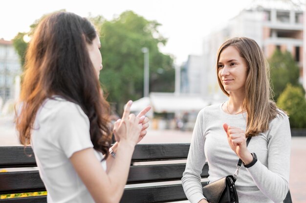 Deaf women communicating through sign language