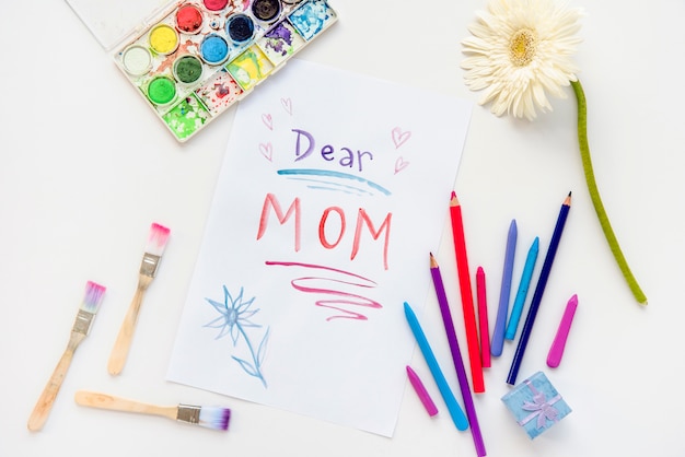 Free photo dear mom inscription on paper with pencils