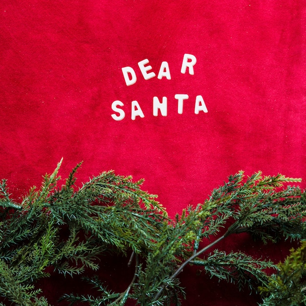 Free photo dear santa title between green coniferous branches