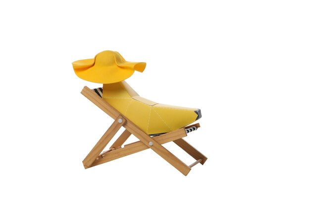 Deck chair with decorative banana with hat isolated on white background