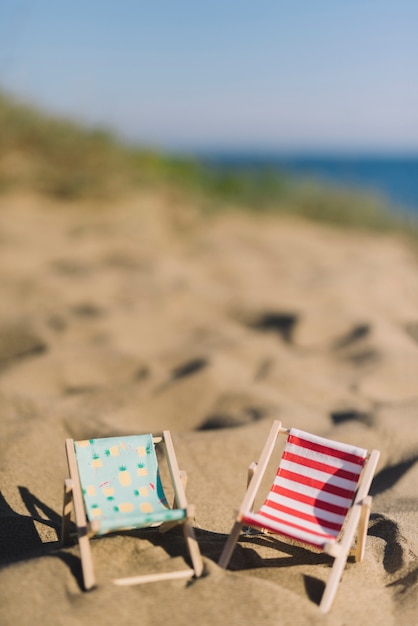 Free photo deck chairs on the sand