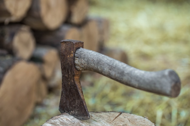 deck of stacked logs and an axe