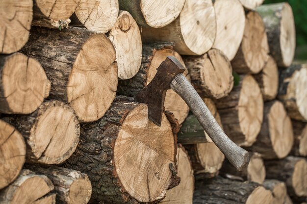 A deck of stacked logs and an axe