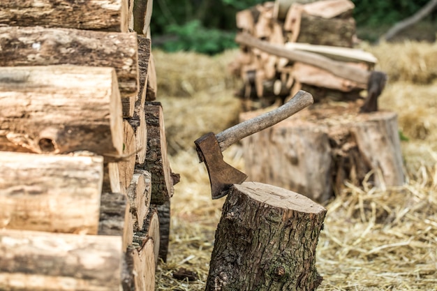 Free photo a deck of stacked logs and an axe